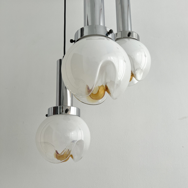 A Mezzega chandelier in a cascading trio of opaline to amber glass from the 1970s image